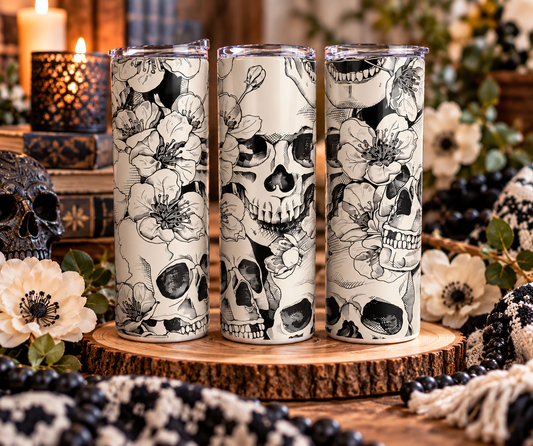 Floral Skulls skinny tumbler displayed with candles, flowers and gothic-inspired decor