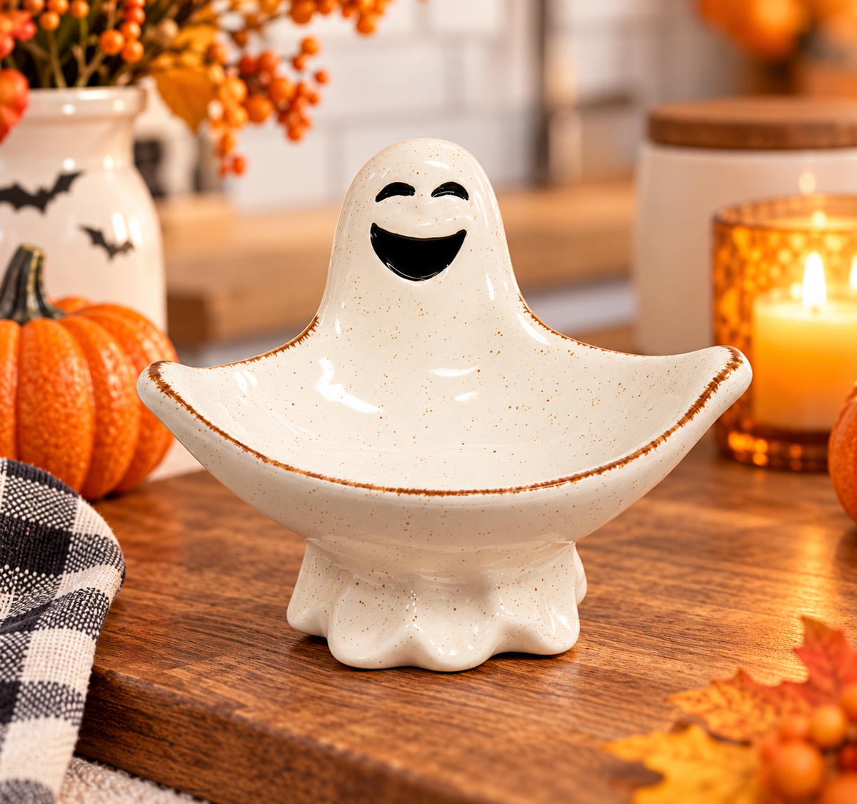 Ceramic ghost candy dish with smiling black face, brown speckles and rustic brown edges for Halloween décor
